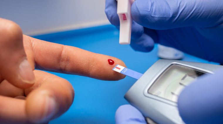 A closeup shot of a doctor with rubber gloves taking a blood test from a patient